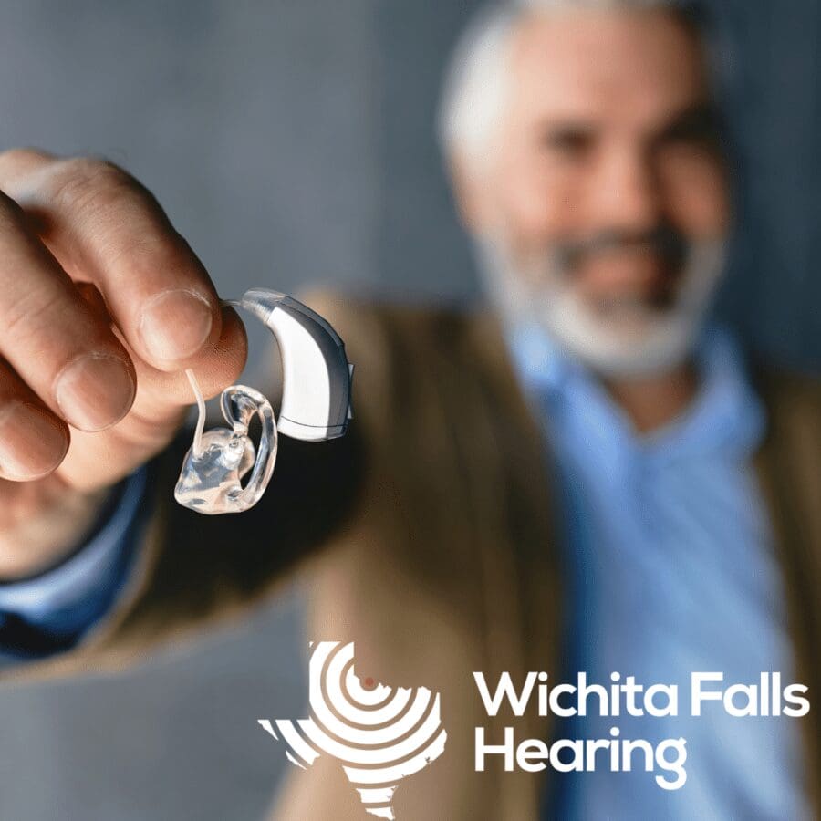 man holding a hearing aid in his hand